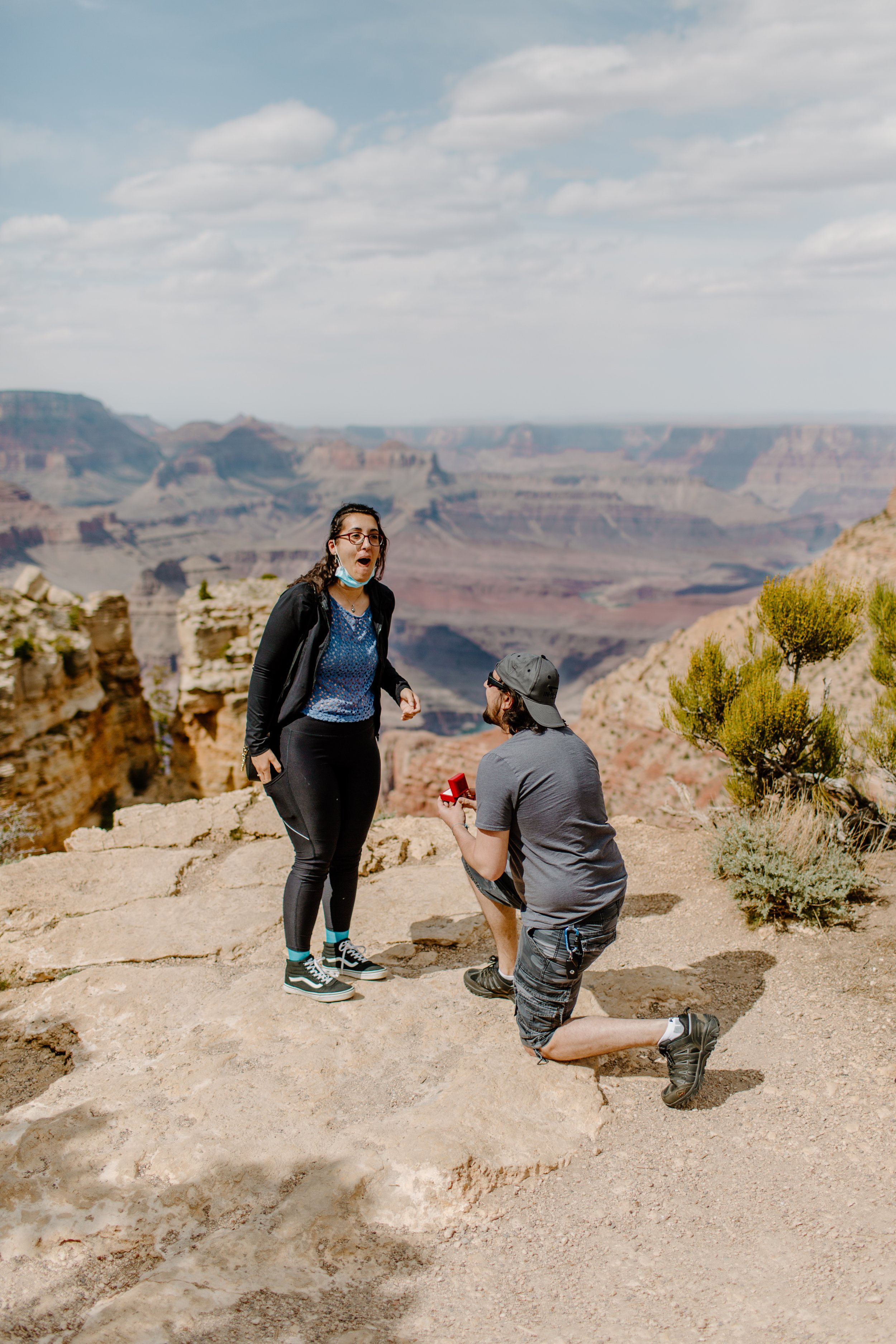  Man proposes to his girlfriend at the edge of the Grand Canyon and she reacts with great surprise 