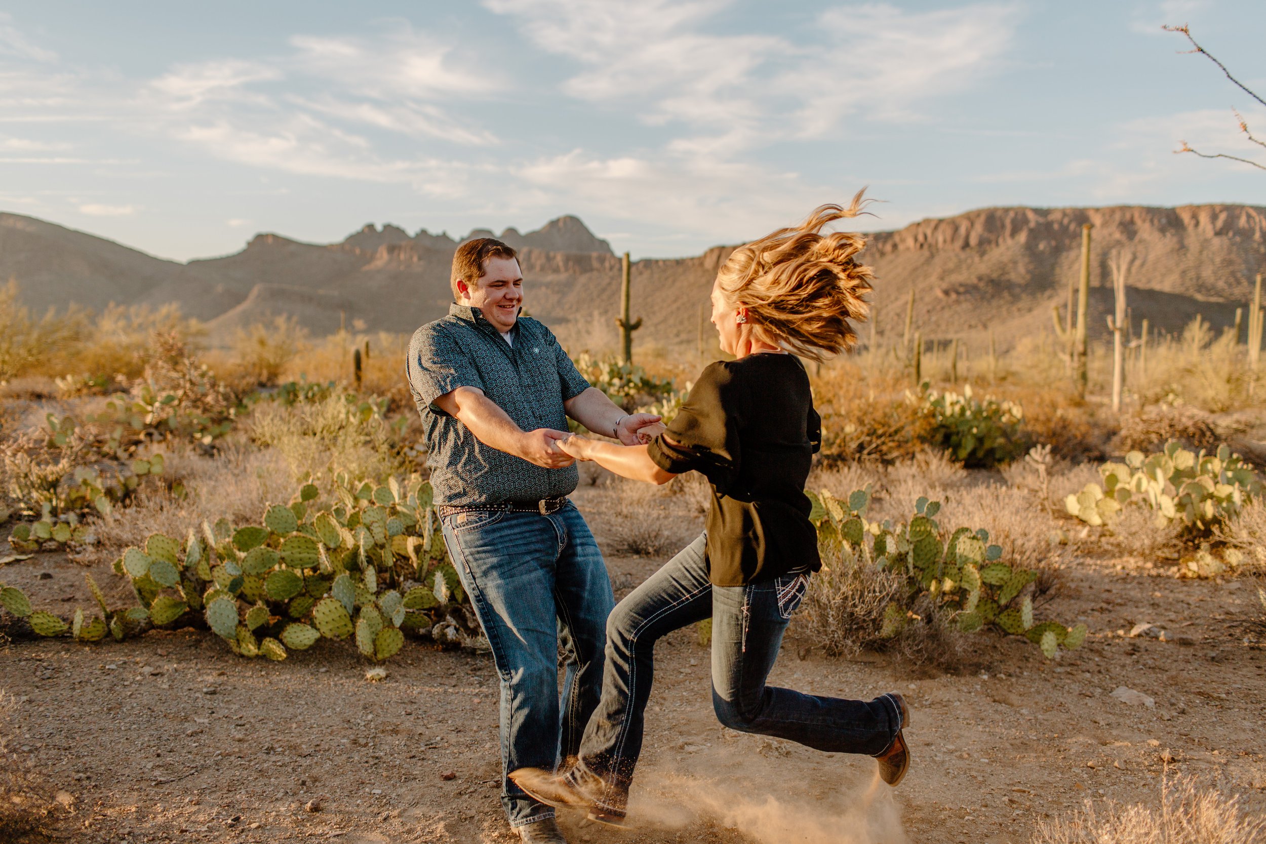  Couple spinning around happily and wildly in Saguaro National Park in Tucson Arizona 