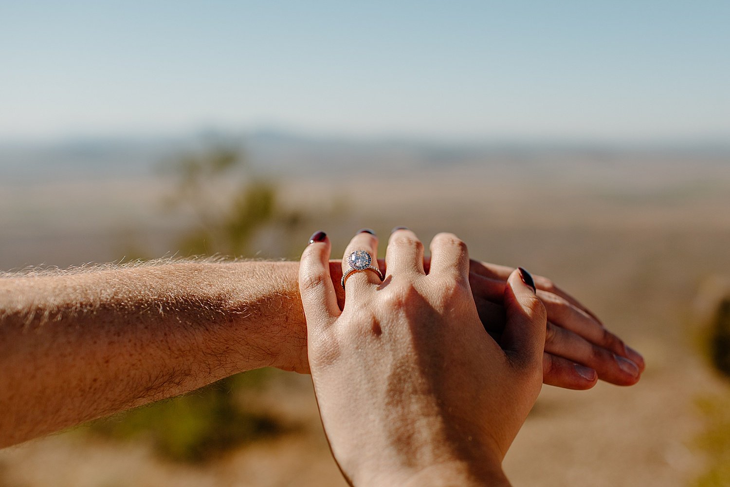  showing off diamond engagement ring at Picacho Peak proposal session  by Lucy Bouman Photography 