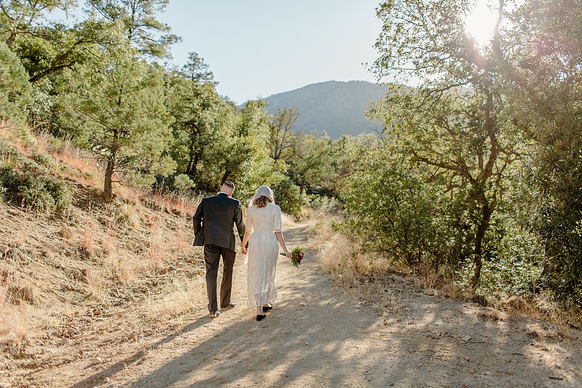  married couple walking the path in Madera canyon before Tucson vow renewal  