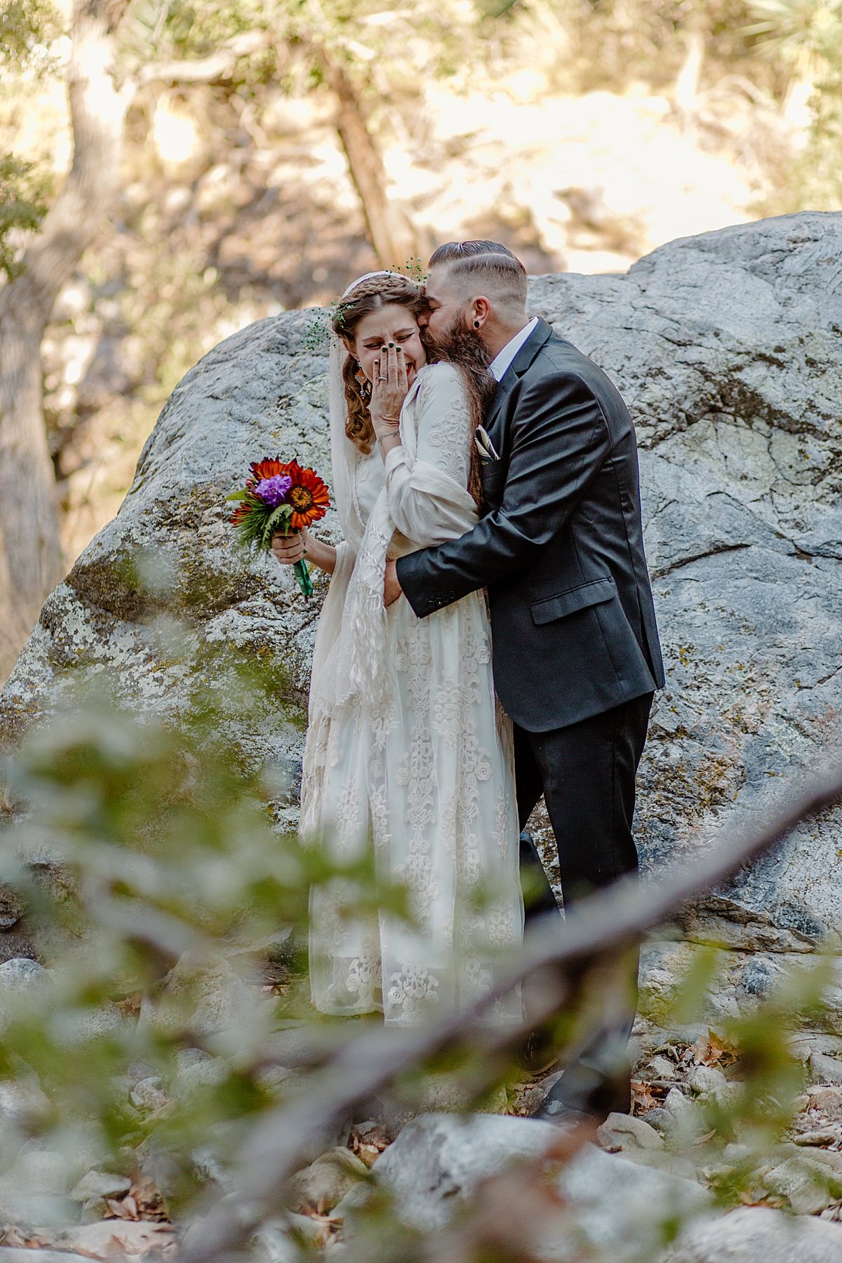  happy bride being held by groom under the trees in Madera canyon by Lucy Bouman 