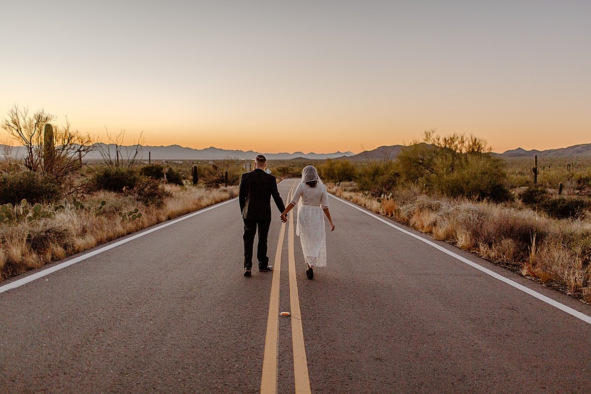  bride and groom walking the streets of Tucson after vow renewal at Sunset  