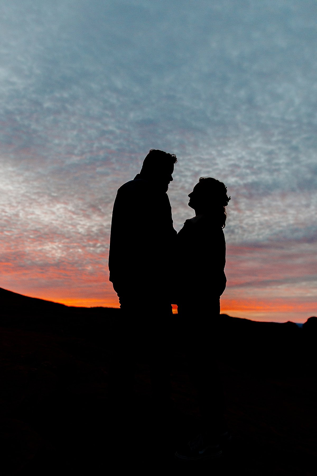  sunrise Utah adventure session with cloudy skies and silhouette couple 