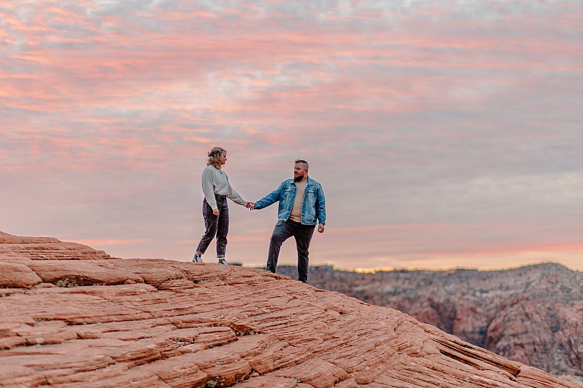  man wearing jean jacket and dark colored jeans while fiancé wears a white long sleeve during engagement session 