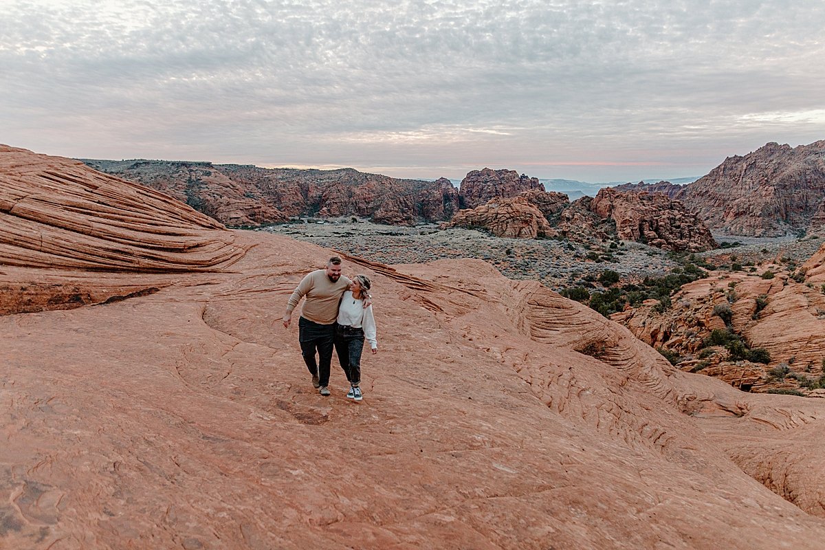  hip bumping each other on the red rocks in Utah state park  