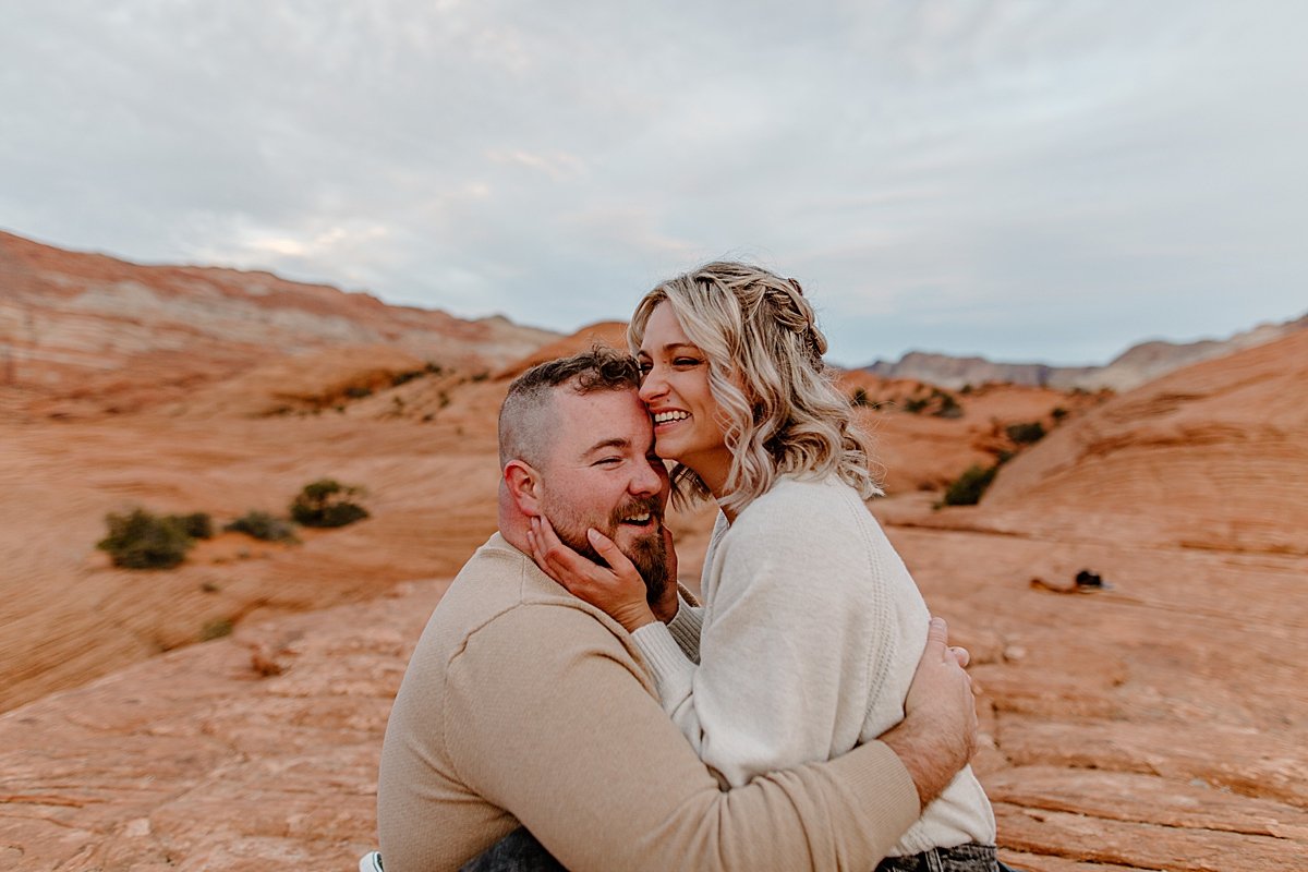  woman sitting on fiancé’s lap at sunrise with Arizona coupes photographer  