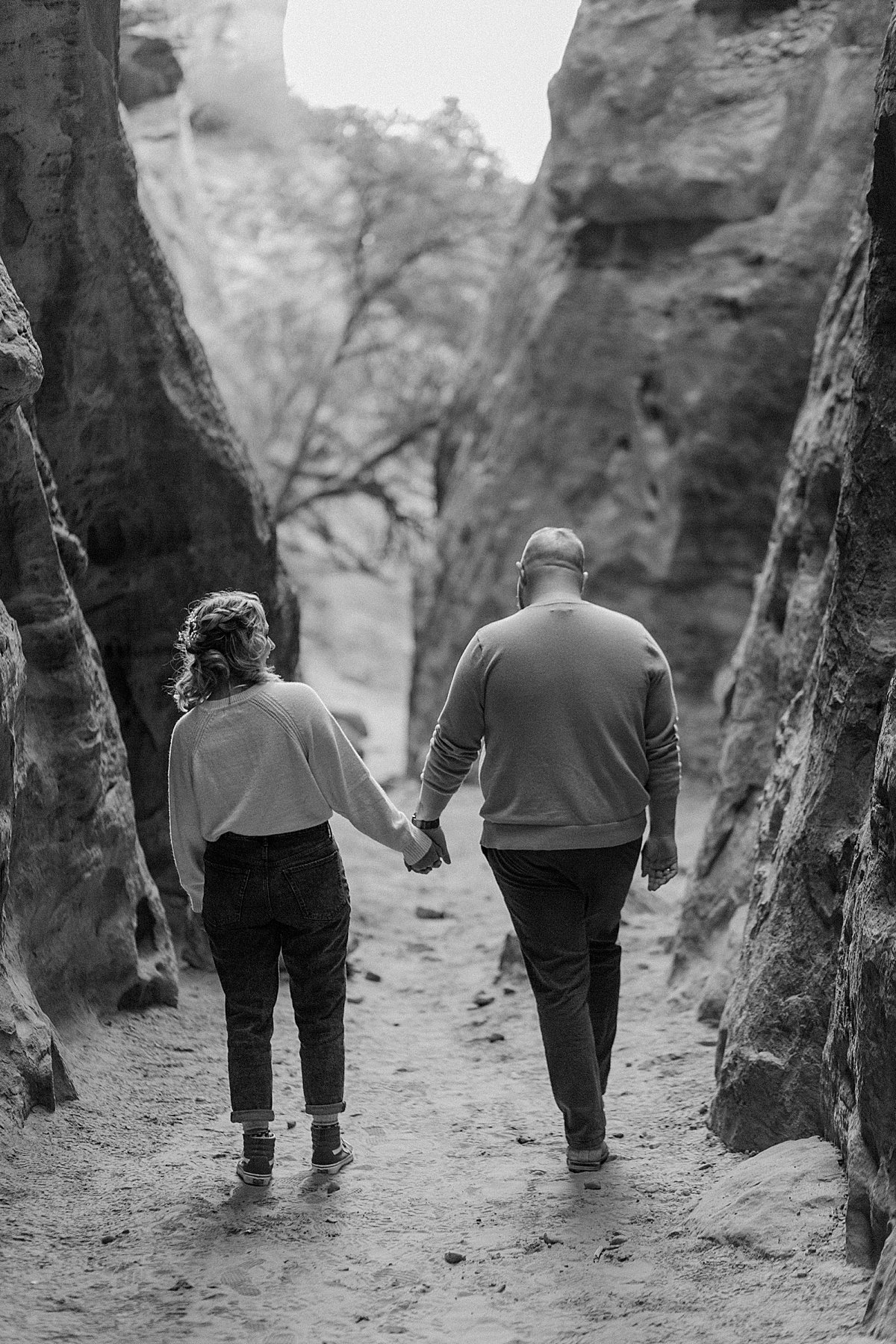  holding hands and walking away from the photographer in slot canyons 