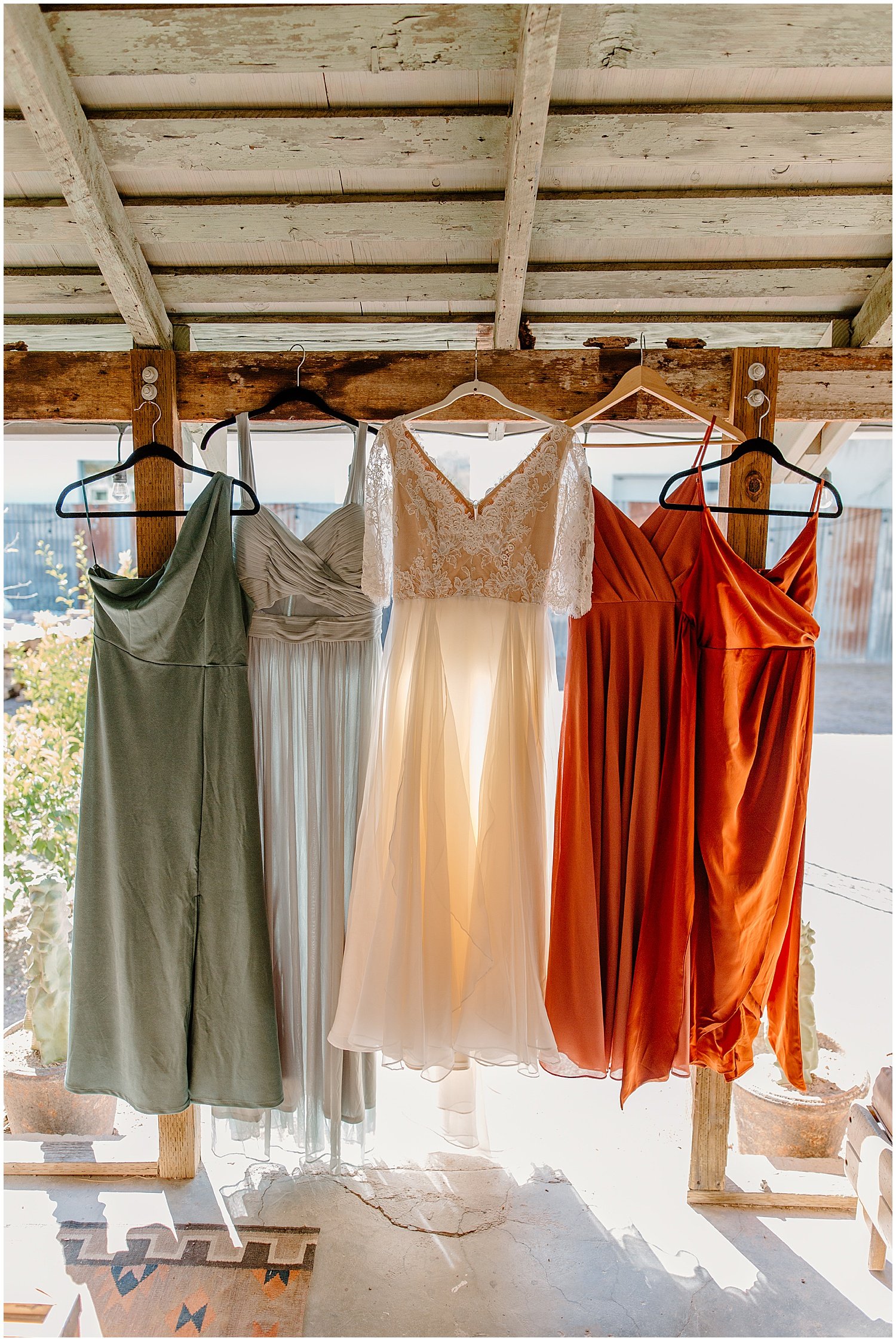  wedding dress with bridesmaids dresses hung up at airbnb Tucson Intimate Wedding 