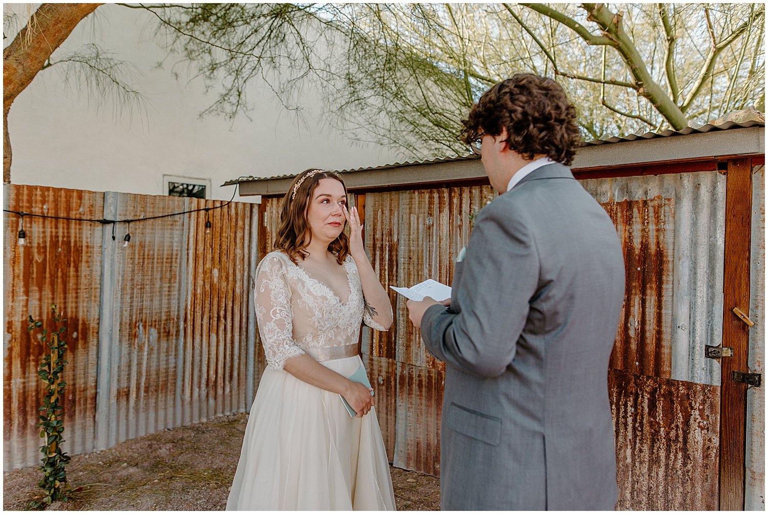  first look with bride and groom while bride wiping tears away from face at Tucson Intimate Wedding 