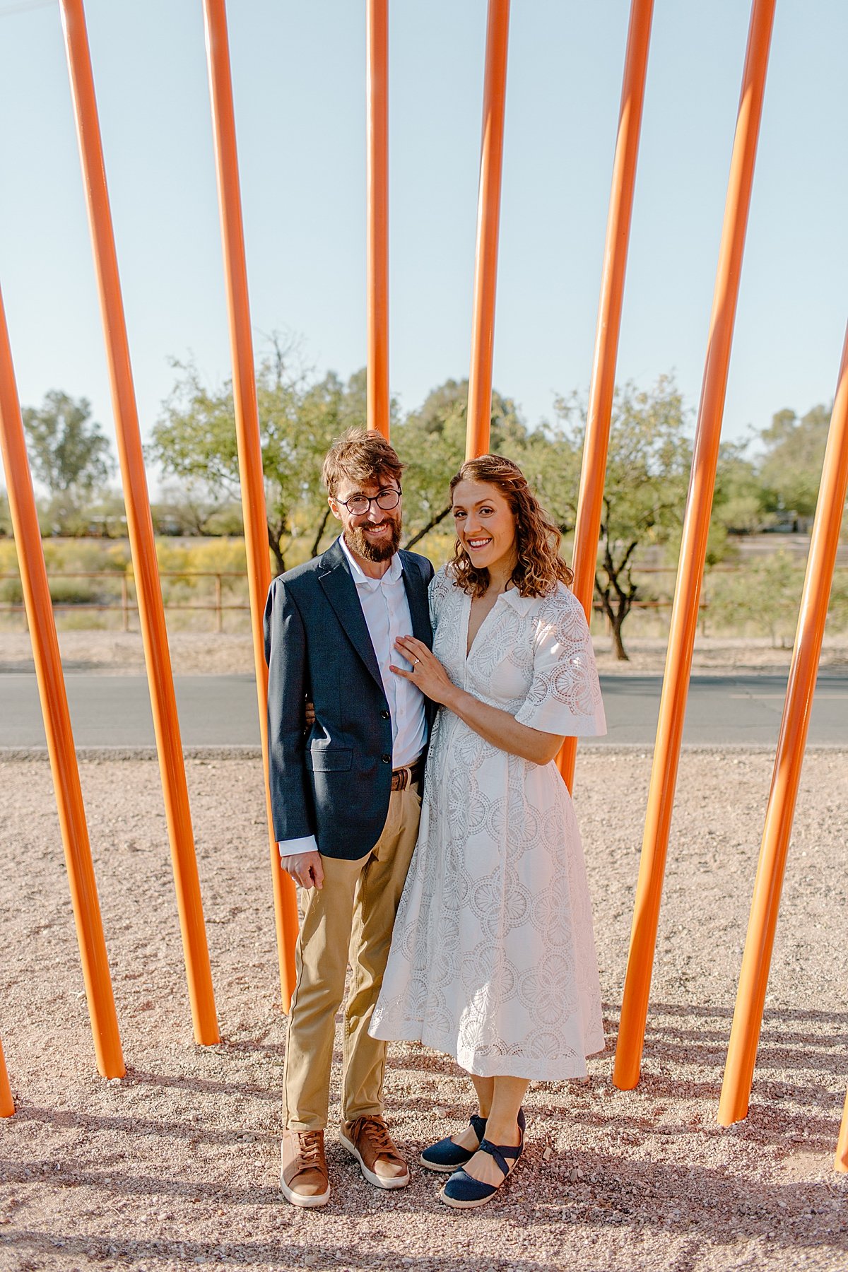  downtown Tucson engagement session with couple wearing white dress and suit coat  