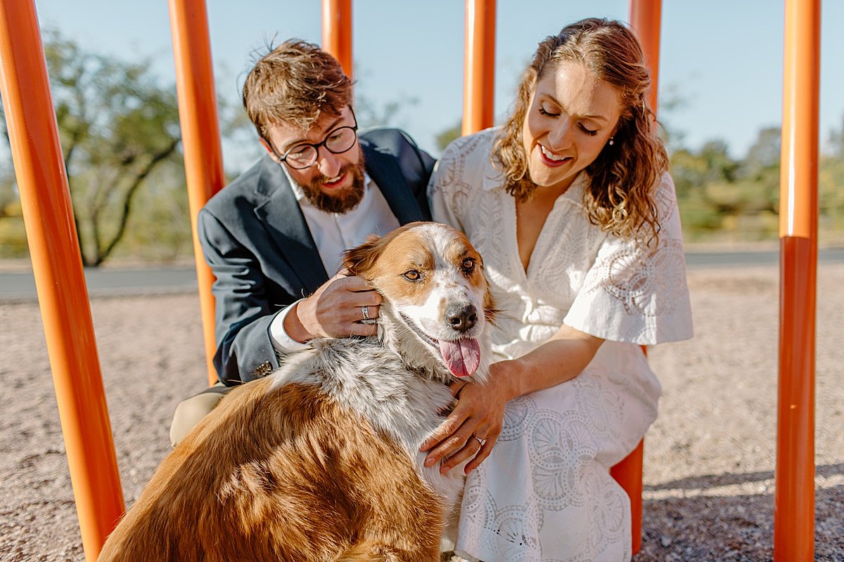  downtown Tucson engagement session with man and woman loving up on dog midday  