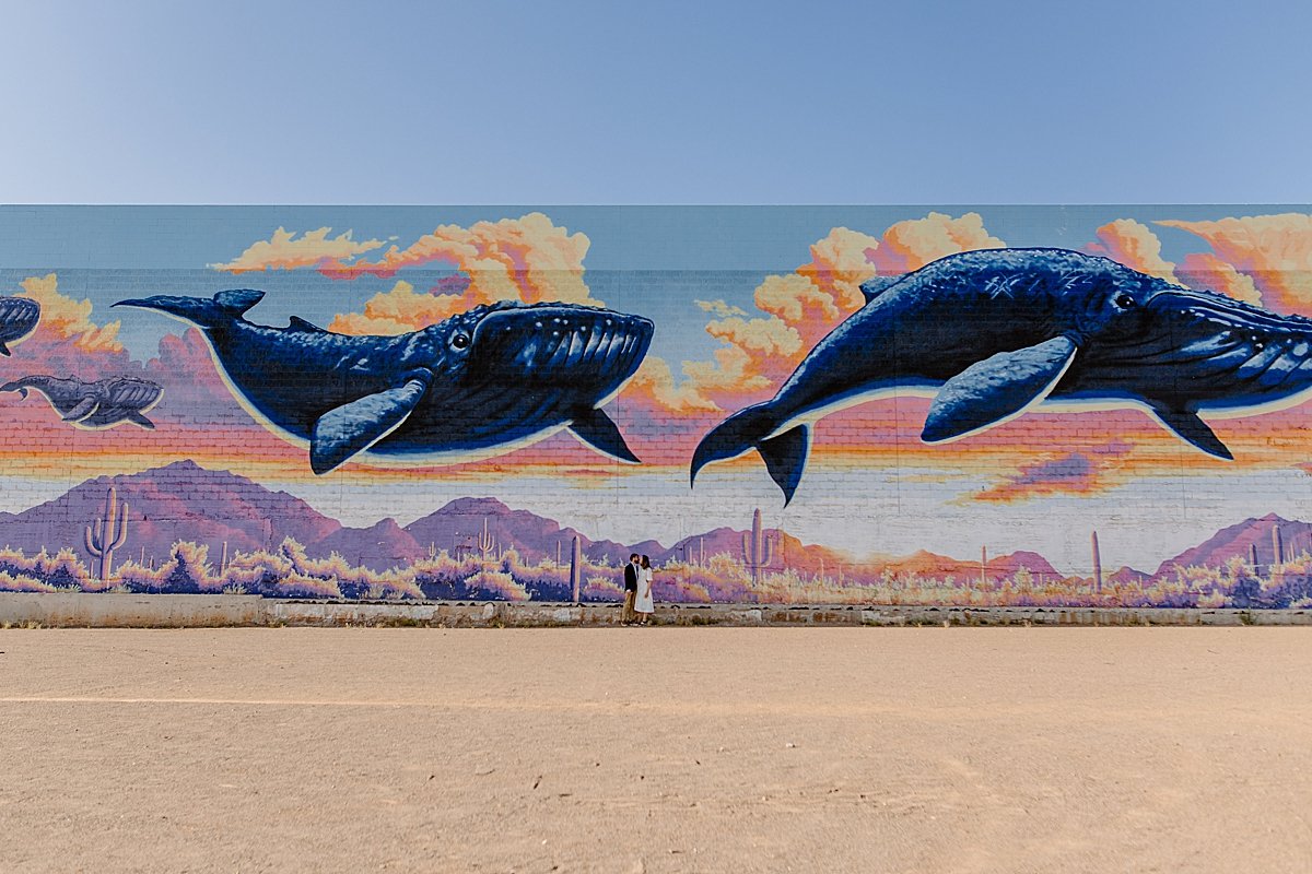  far away shot by Lucy Bouman Photography  of whale mural with engaged couple  