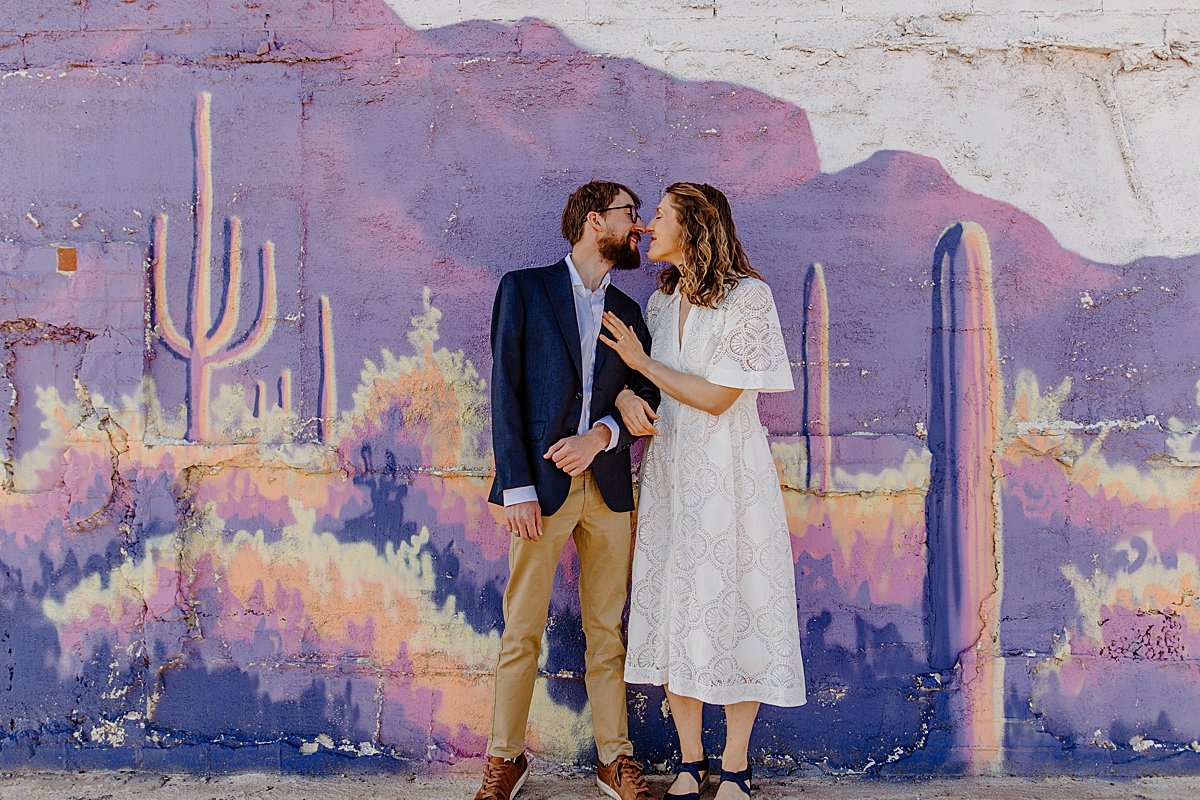  downtown Tucson engagement session with couple wearing white dress and suit coat  