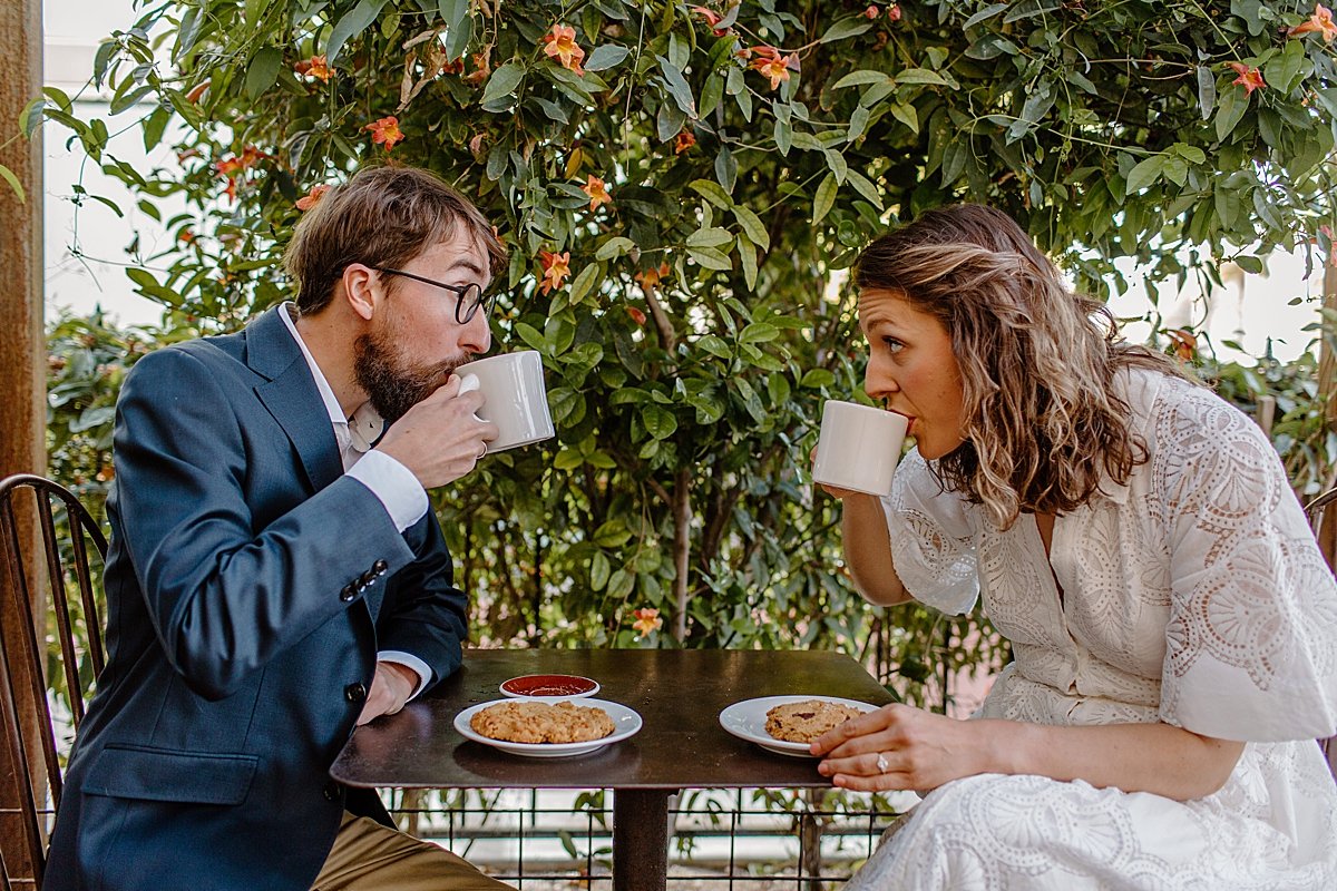  downtown Tucson engagement session with engaged couple drinking coffee at table  