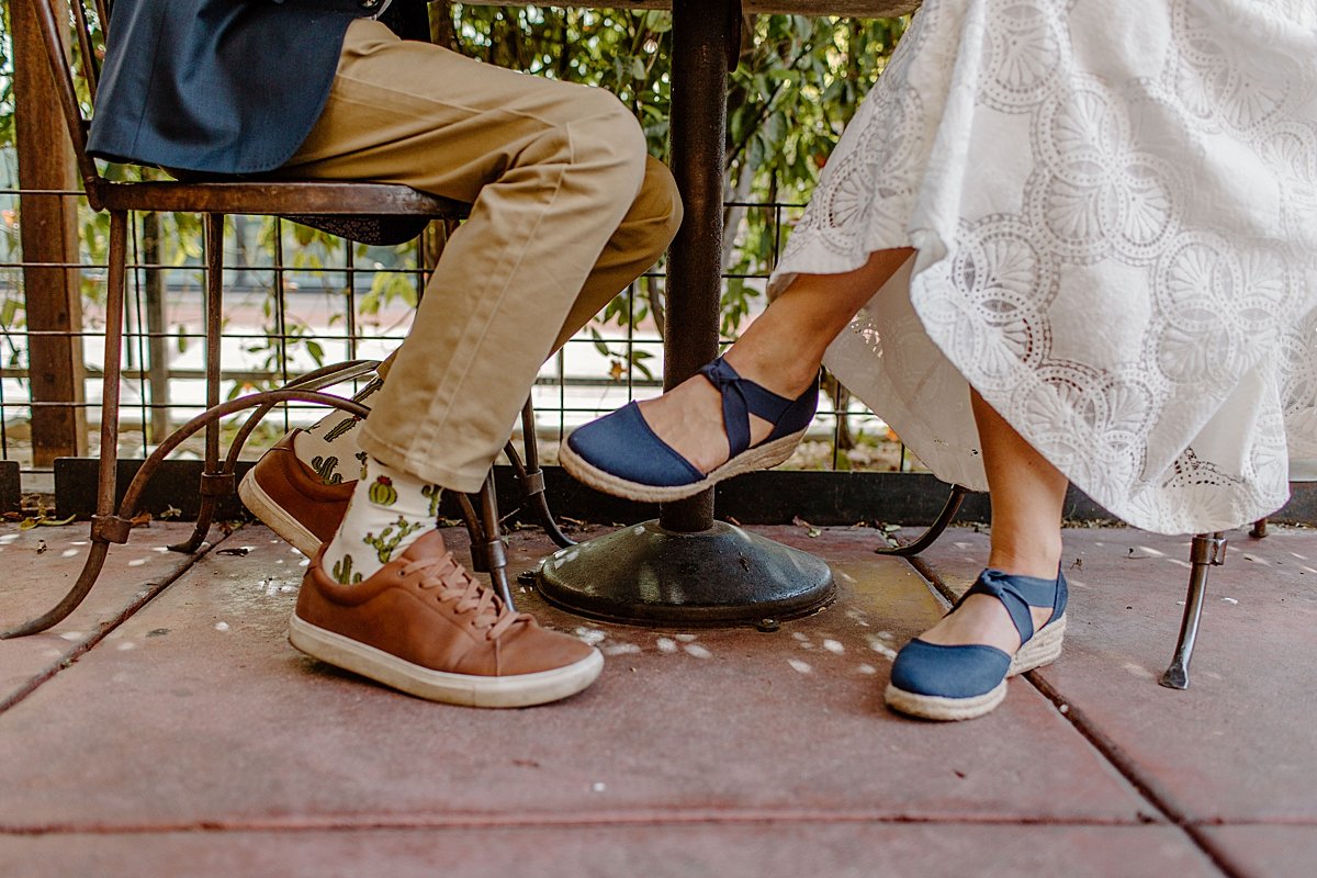  downtown Tucson engagement session showing off shoes at diner drinking coffee  