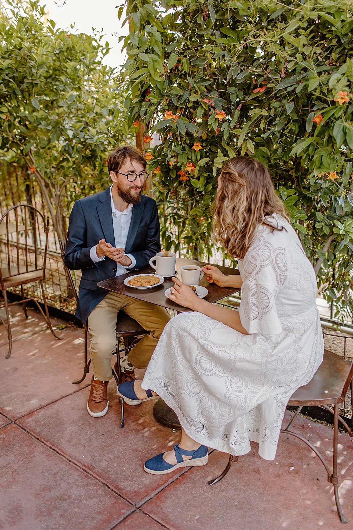  newly engaged man and woman sitting at coffee shop with Lucy Bouman Photography  