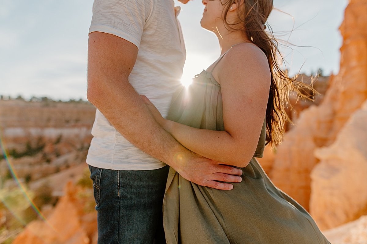  Sunset couple portrait of man and woman standing on red rock by Utah couples photographer 