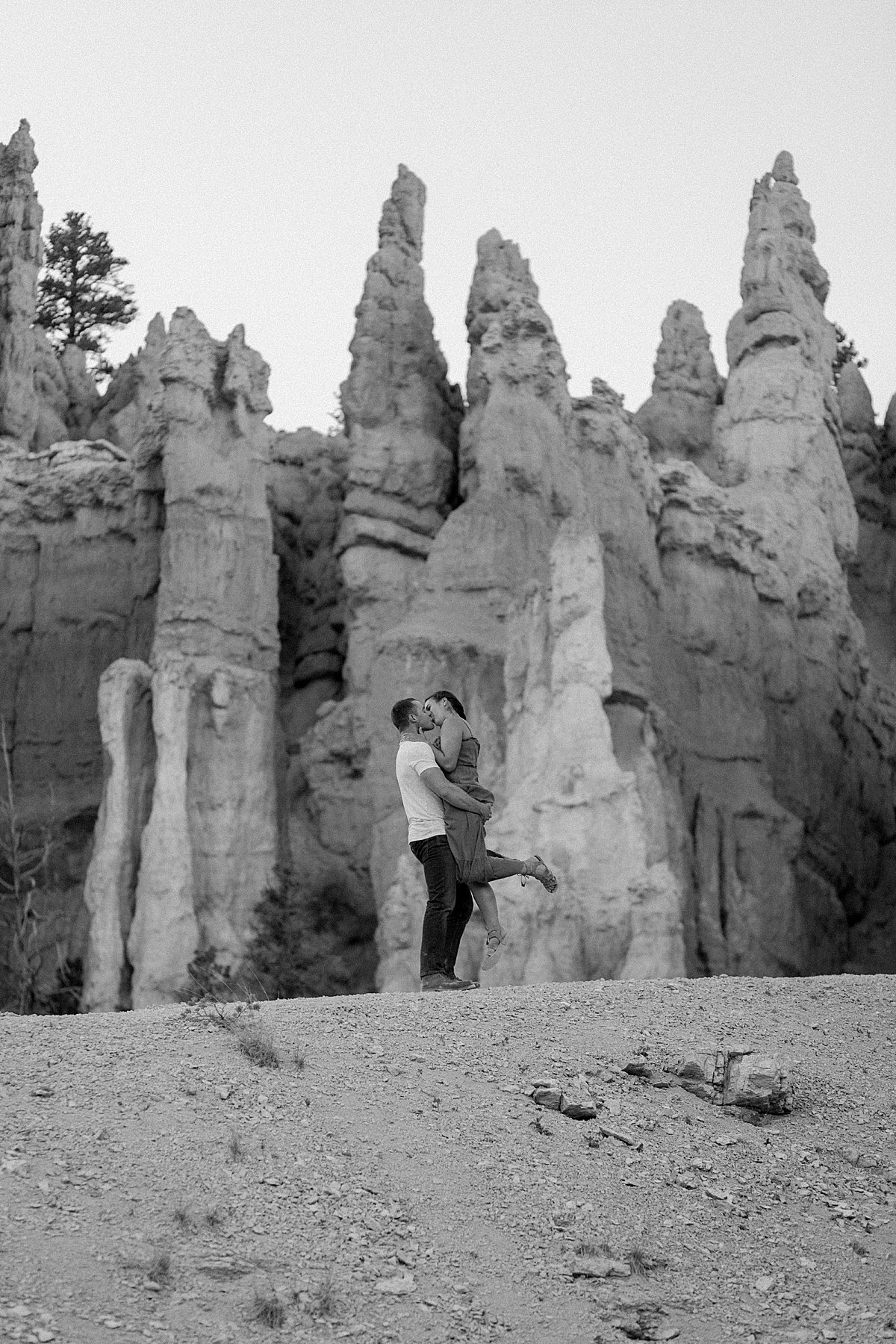  Black and white couple photography with man holding up woman during Bryce Canyon adventure session 