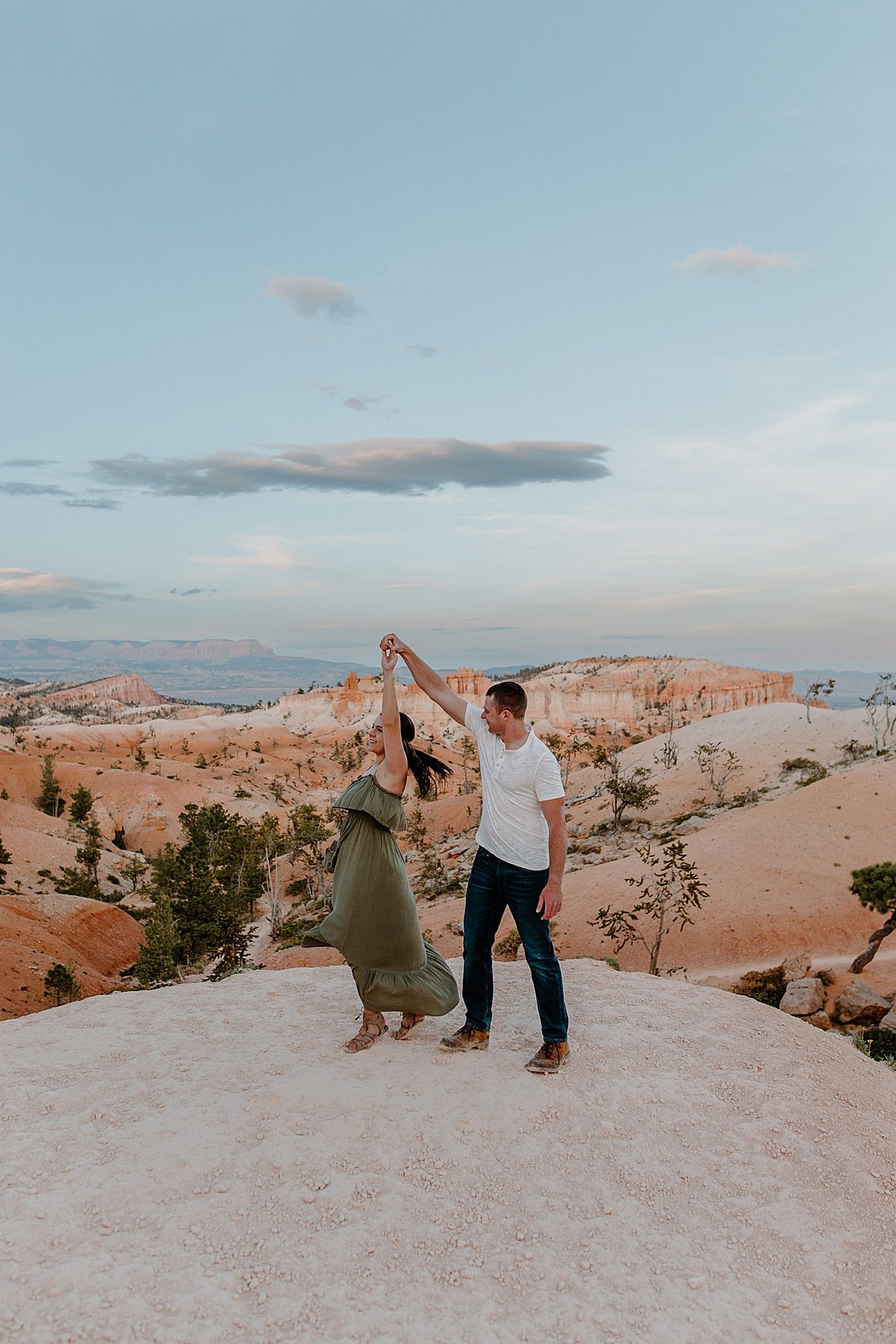  Couple twirling on the ledge of Bryce Canyon by Utah couples photographer 