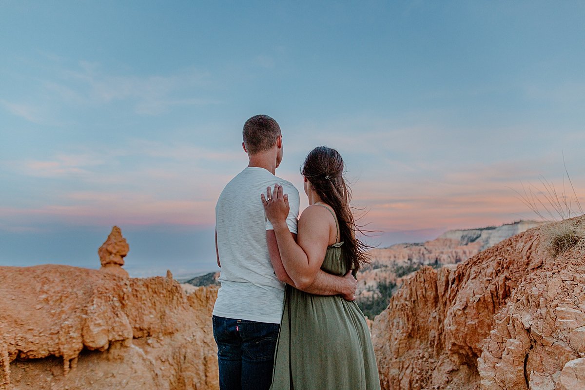  Utah couples photographer standing with engaged couple overlooking bryce canyon 