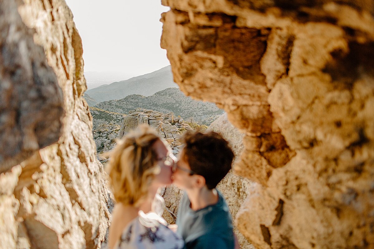  Engaged woman and woman standing between canyons rocks with Tucson engagement photographer 