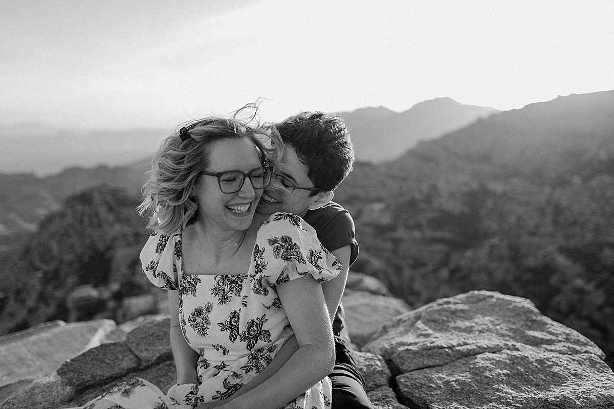  Couple sitting on overlook Mount Lemmon for engagement session at windy point 