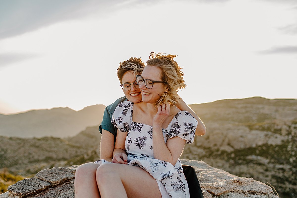  Couple sitting on the overlook at Windy point with Tucson engagement photographer 