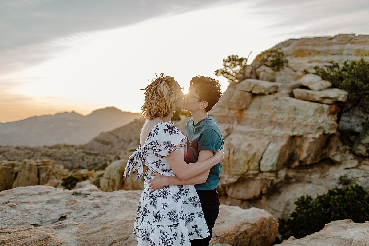  Couple kissing that Windy point for engagement session wearing dress and T-shirt with jeans 
