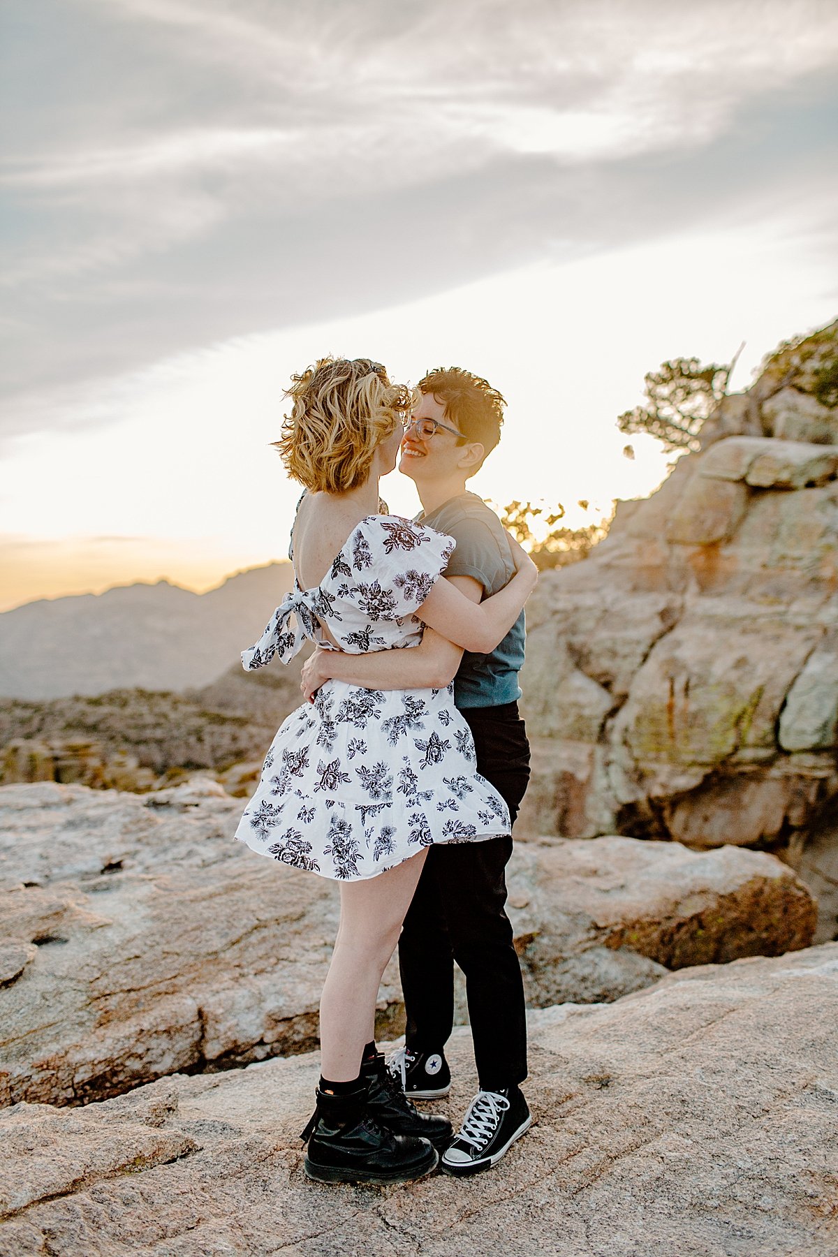  Girls kissing at sunset on the rocks wearing dress by Lucy Bouman photography 