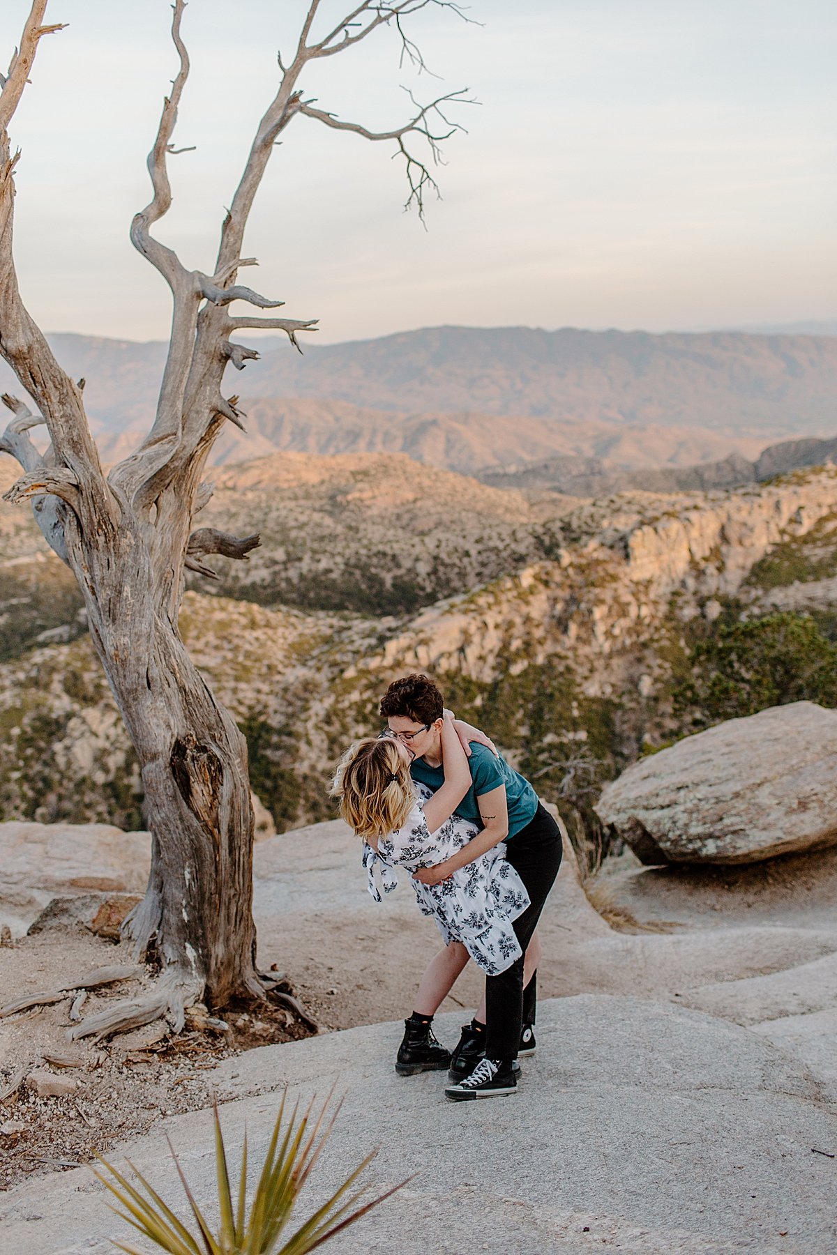  Girl dipping other girl overlooking Canyon windy point for engagement session 