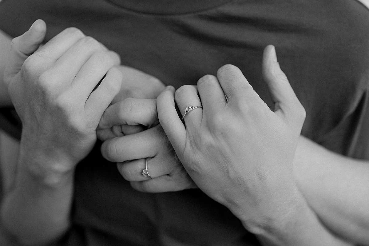  Showing off engagement bands in black-and-white portrait of hands at Windy point 