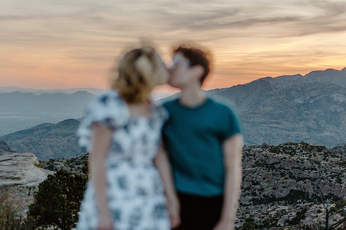  Blurry kissing photo of couple overlooking canyon of Mount Lemmon by Lucy Boumanphotography 