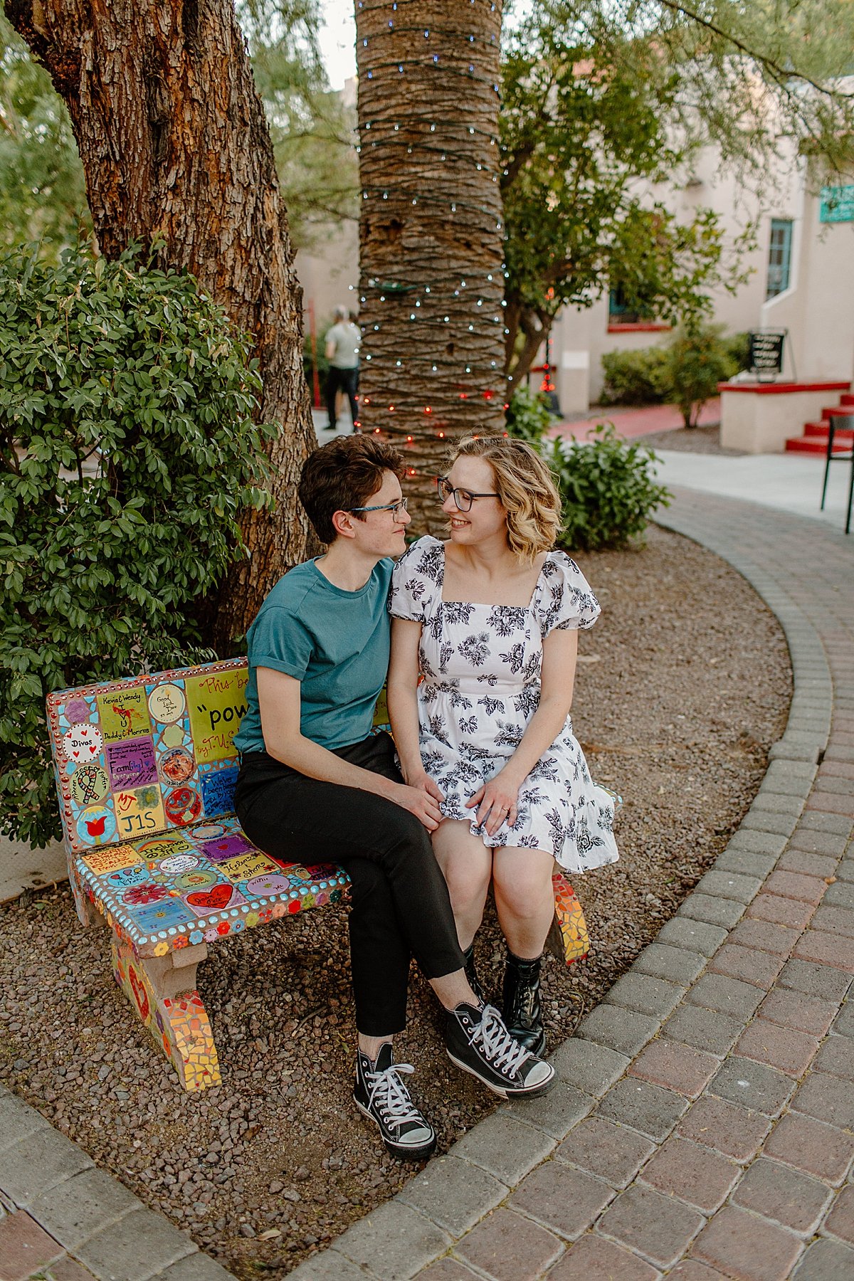  Girl couple sitting on bench at Arizona campus for engagement session by Lucy Bouman photography 