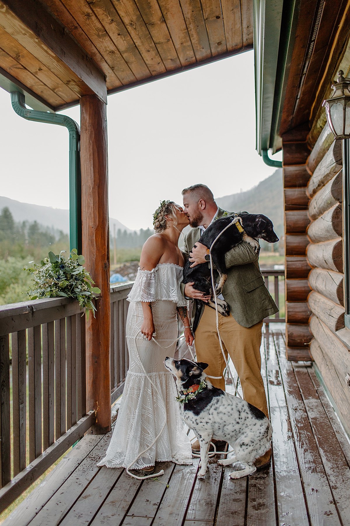  Bride and groom holding two dogs before hiking by Arizona adventure elopement photographer 