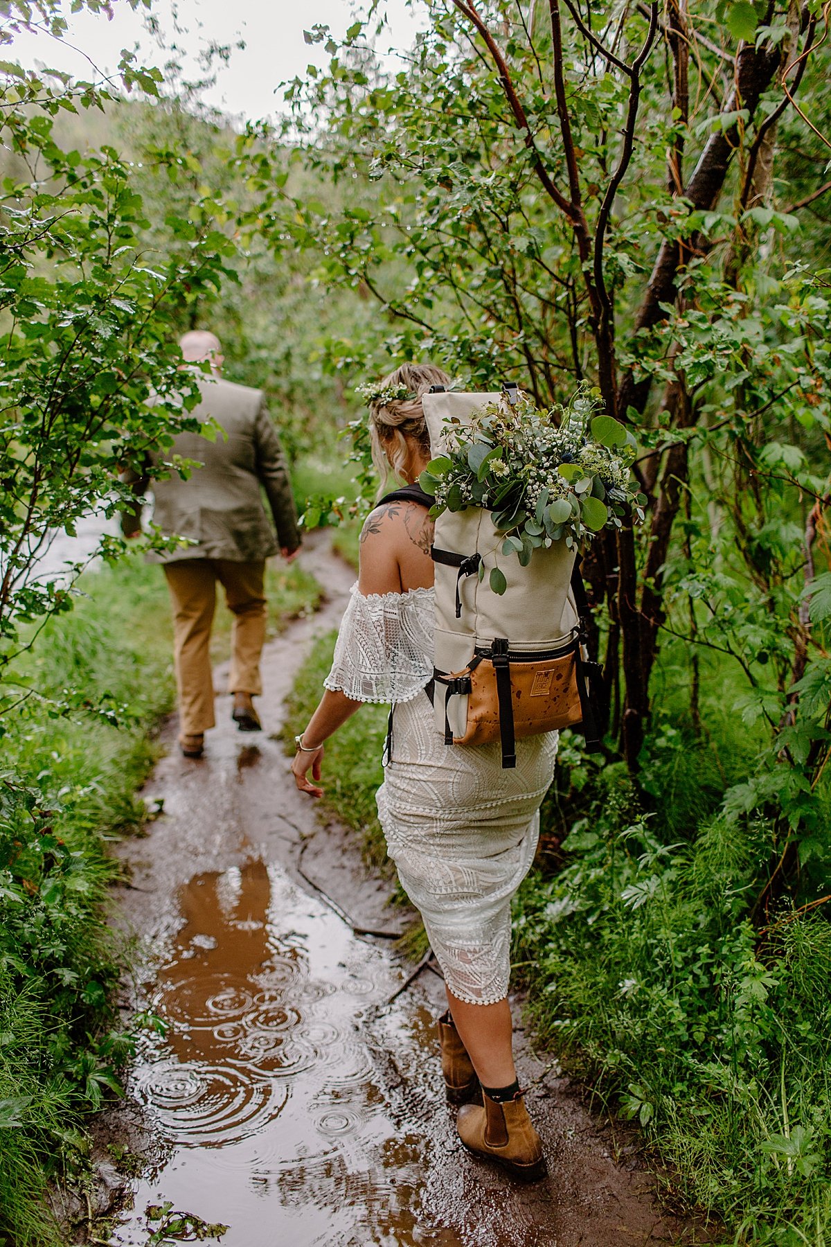  Newly married couple walking with backpacks and hiking boots to elopement location by Arizona adventure elopement photographer 