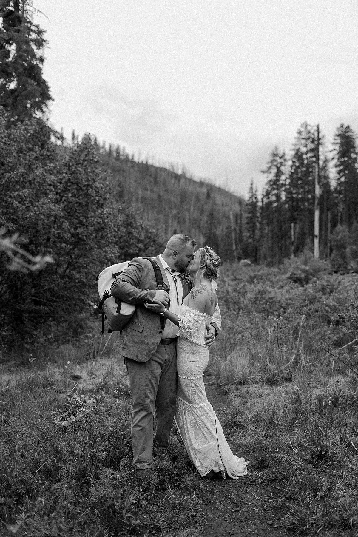  Black and white portrait of Bride and Groom dancing in the mountains before ceremony 