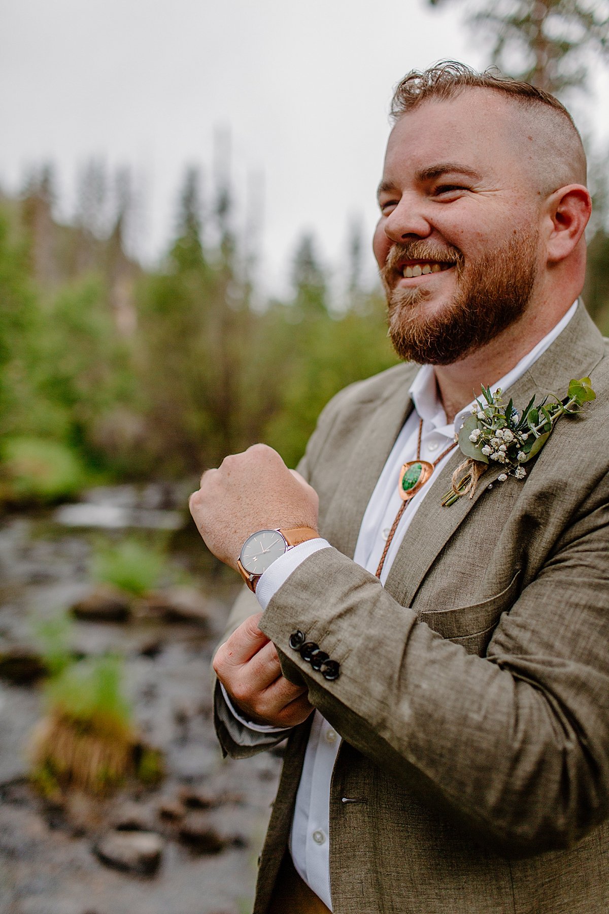 Portrait of groom showing a wristwatch on River by Arizona adventure elopement photographer 