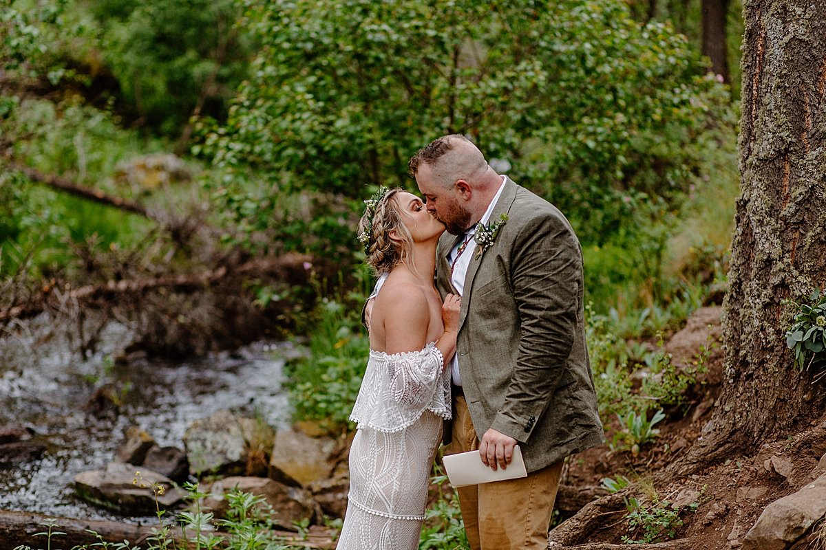  Bride and groom share first kiss after reading personal vows by Arizona adventure elopement photographer 