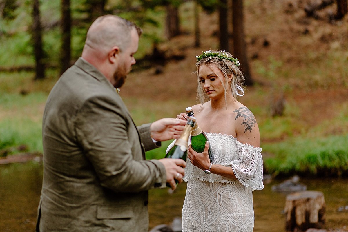  Newly married couple Opens bottle of champagne after saying I do  by Lucy Bouman 