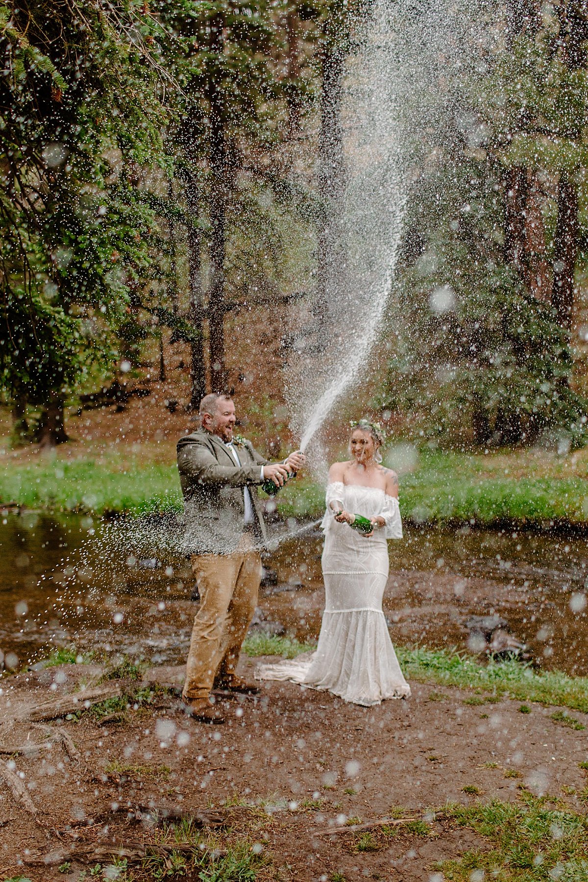  Bride and groom popping bottle of champagne After Greer elopement in the mountains 