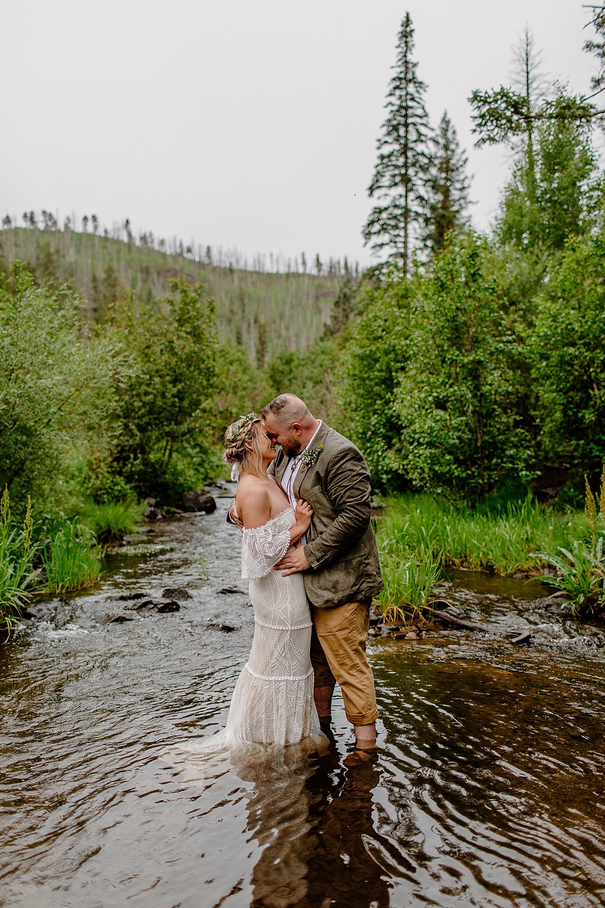  Couple splashing in the river of elopement location by Arizona adventure elopement photographer 