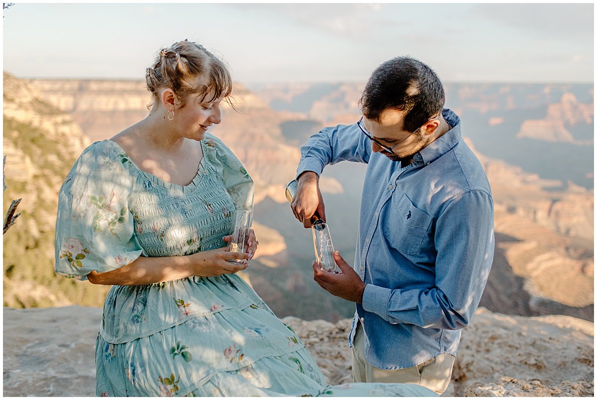  Man pours champagne at Grand Canyon Engagement Session 