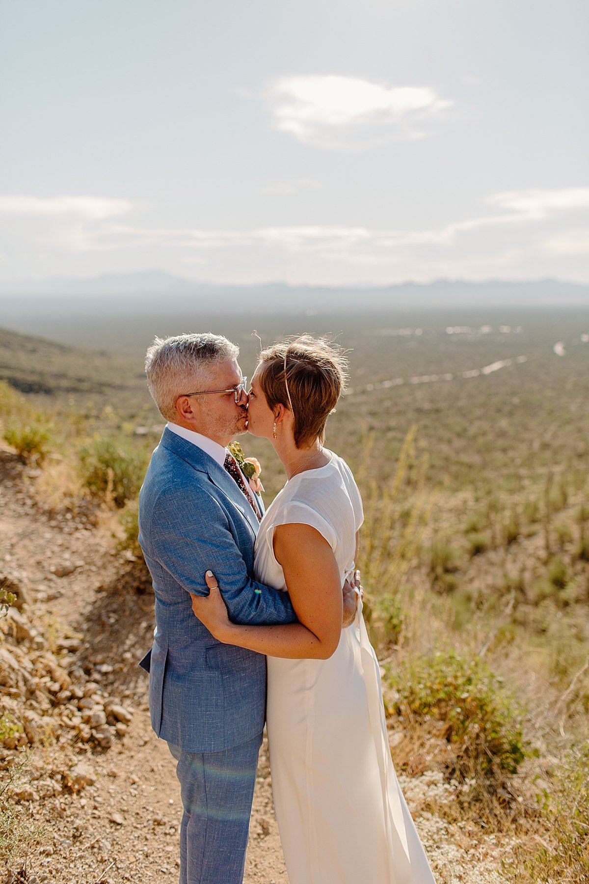  bride and groom kiss in desert by Tucson Elopement photographer 