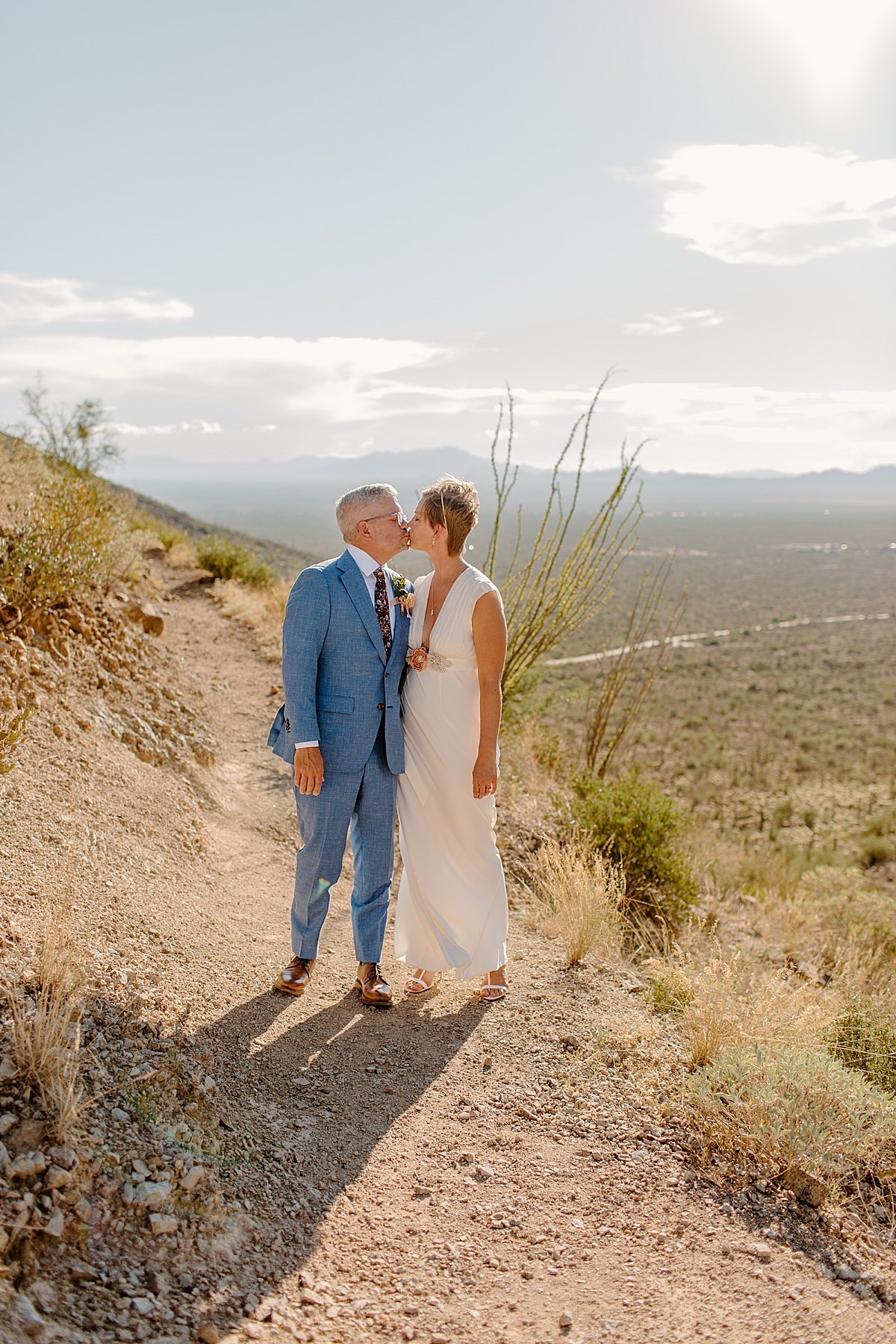  Groom in blue suit with his bride outdoors by Tucson Elopement photographer 