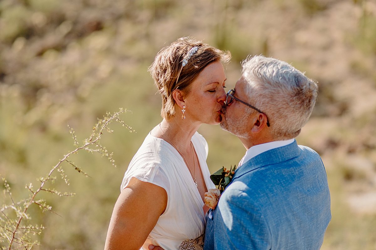  Middle aged bride and groom kiss at micro wedding by Lucy Bouman Photography 