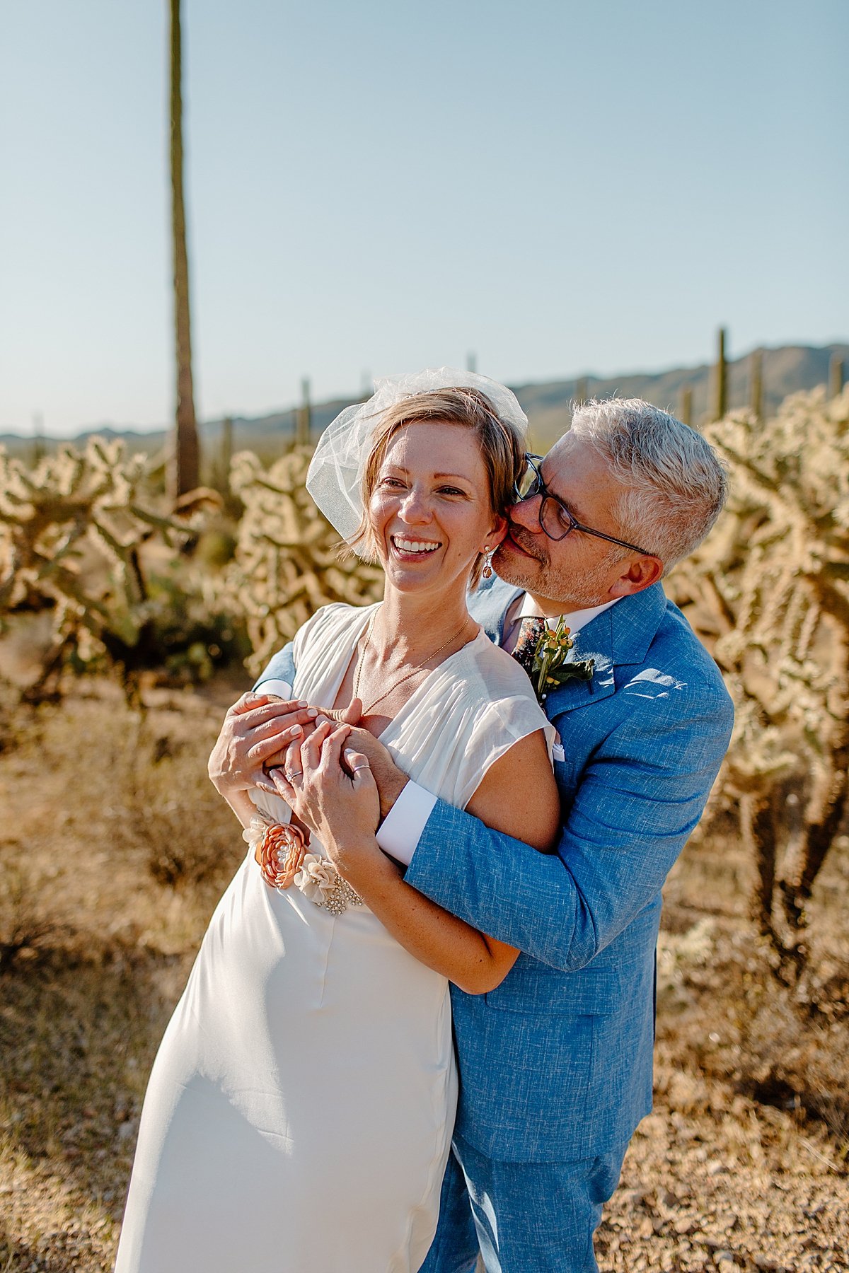  Groom wrapping up his bride with love by Tucson Elopement photographer 