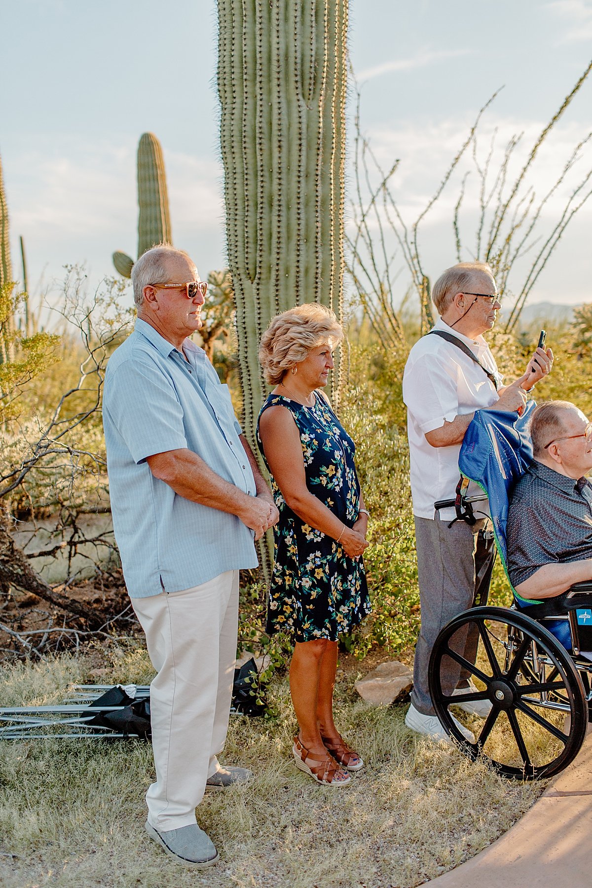  Guests watching micro wedding in desert  by Lucy Bouman Photography 