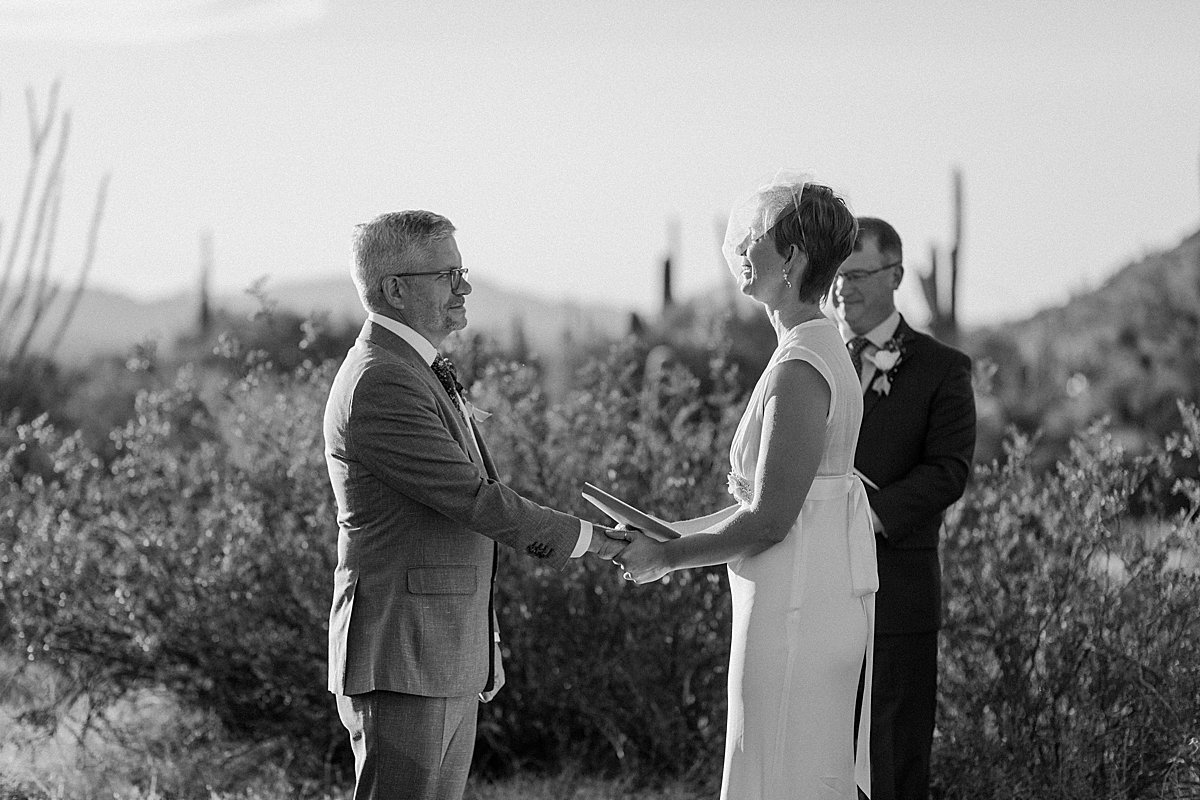  Couple saying I Do at outdoor Arizona ceremony  by Lucy Bouman Photography 