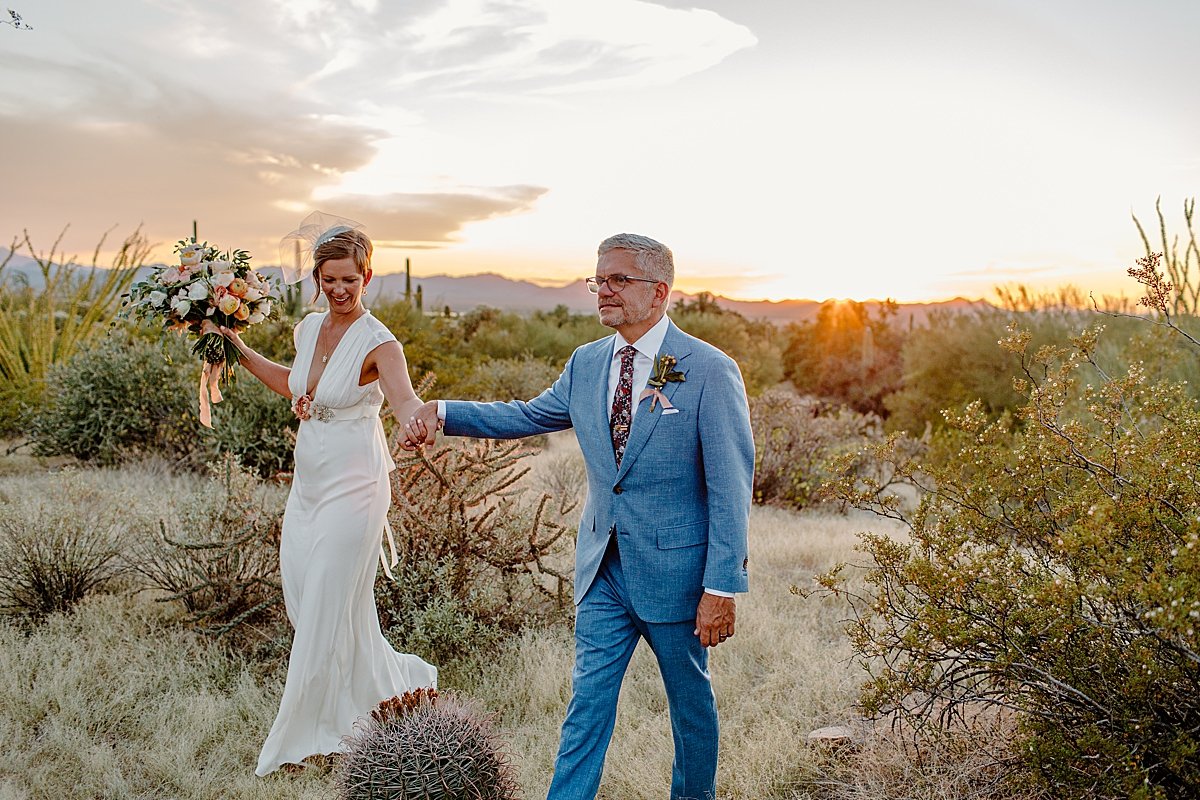  Bride and groom walk the canyon at Saguaro National Park 