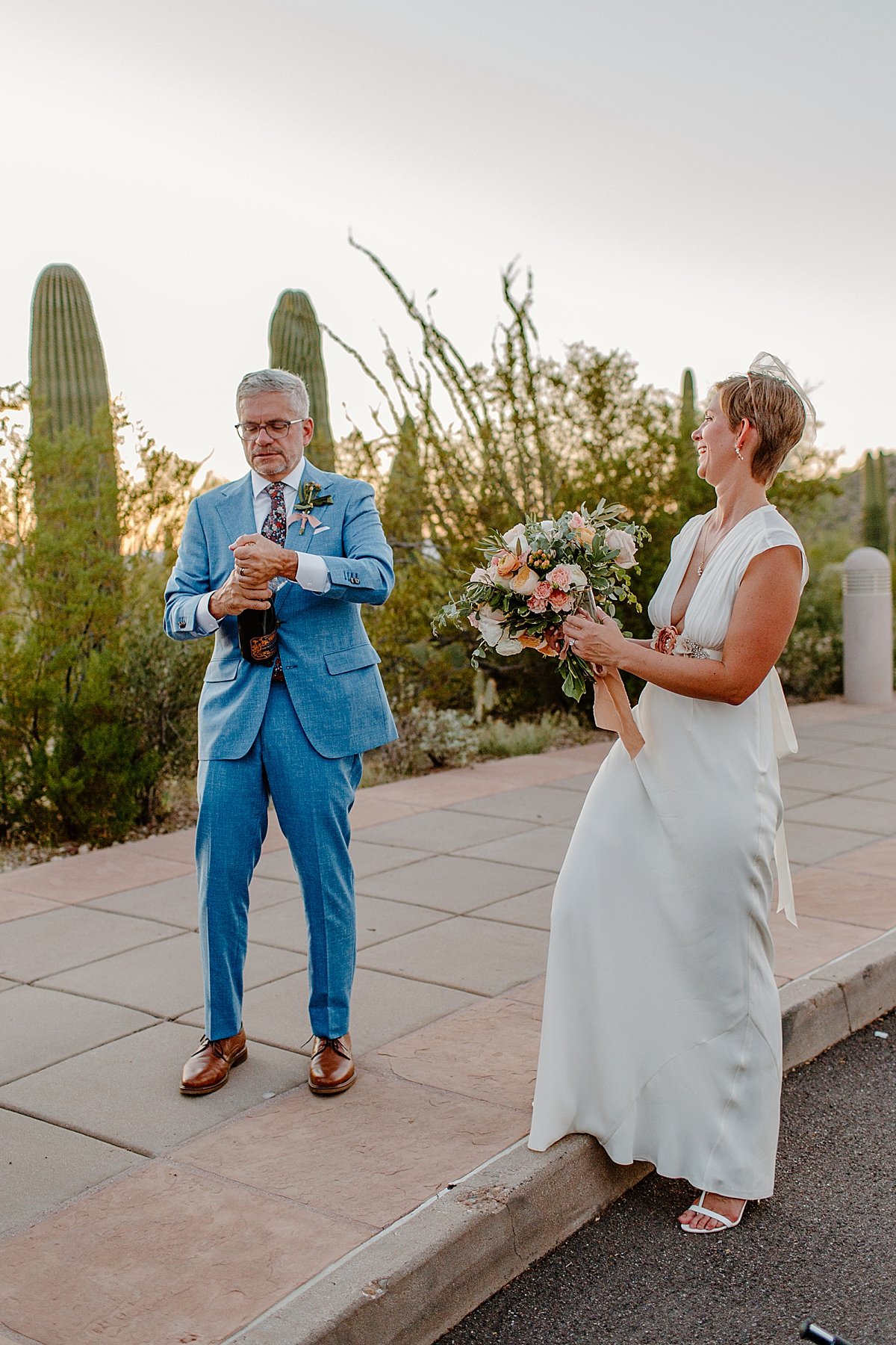  Newlyweds pop champagne at Saguaro National Park 